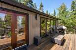 Enjoy outdoor living on this spacious wooden deck, perfect for entertaining or relaxing amidst nature.