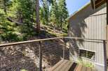 Experience the serene mountain lifestyle from this charming deck, offering a picturesque view of a lush, wooded hillside.