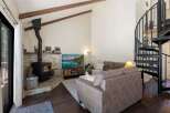 Cozy living room featuring a stone-clad fireplace with a wood-burning stove, perfect for chilly evenings.