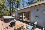 Enjoy ultimate relaxation on this spacious wooden deck, featuring a luxurious hot tub perfect for unwinding under the stars.