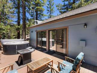 Enjoy ultimate relaxation on this spacious wooden deck, featuring a luxurious hot tub perfect for unwinding under the stars.