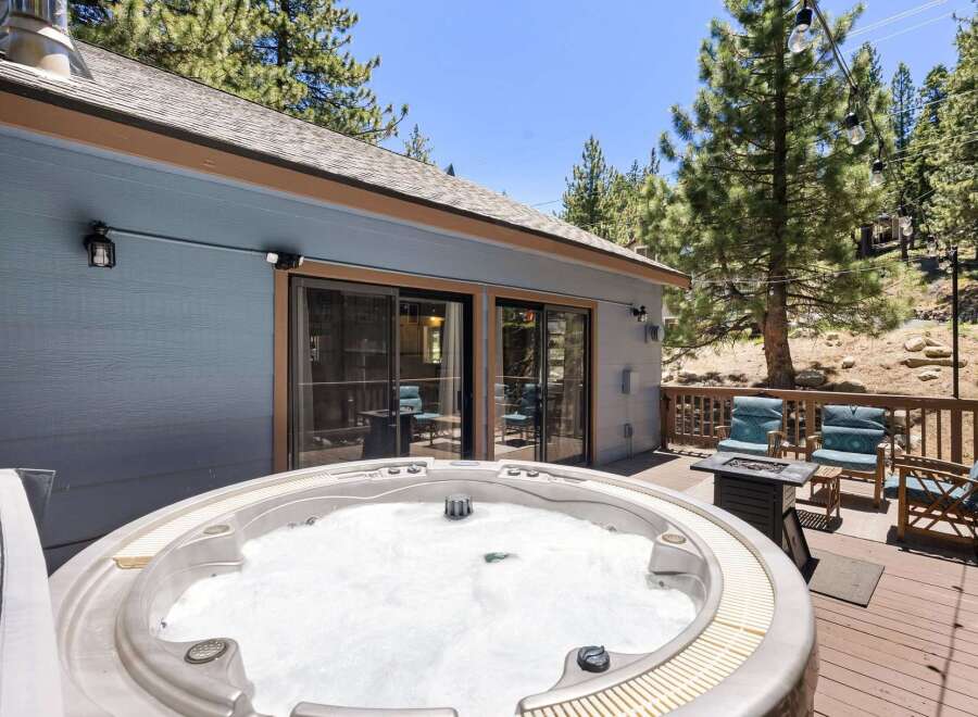 Relax and unwind in this stunning mountain retreat, featuring a luxurious hot tub perfect for soaking under the stars.
