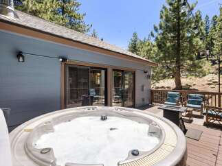 Relax and unwind in this stunning mountain retreat, featuring a luxurious hot tub perfect for soaking under the stars.