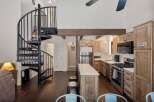 Discover this charming home featuring a stunning spiral staircase leading to an upper level, perfect for maximizing space.