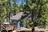 Escape to this charming cabin nestled among tall pine trees, offering a private hot tub on the deck for ultimate relaxation.