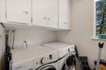 This laundry room features a stacked Whirlpool Duet washer and dryer set, perfect for maximizing space.