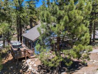 Escape to this charming mountain retreat, nestled amongst tall pine trees.