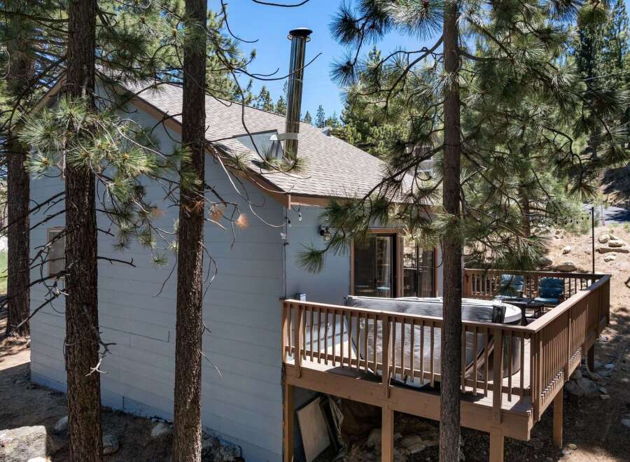 Escape to this charming cabin nestled among tall pine trees, offering a serene mountain retreat.