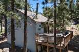 Escape to this charming cabin nestled among tall pine trees, offering a serene mountain retreat.