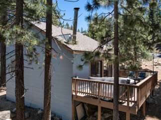 Escape to this charming cabin nestled among tall pine trees, offering a serene mountain retreat.
