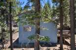Nestled amongst tall pine trees, this charming home offers a serene mountain retreat.