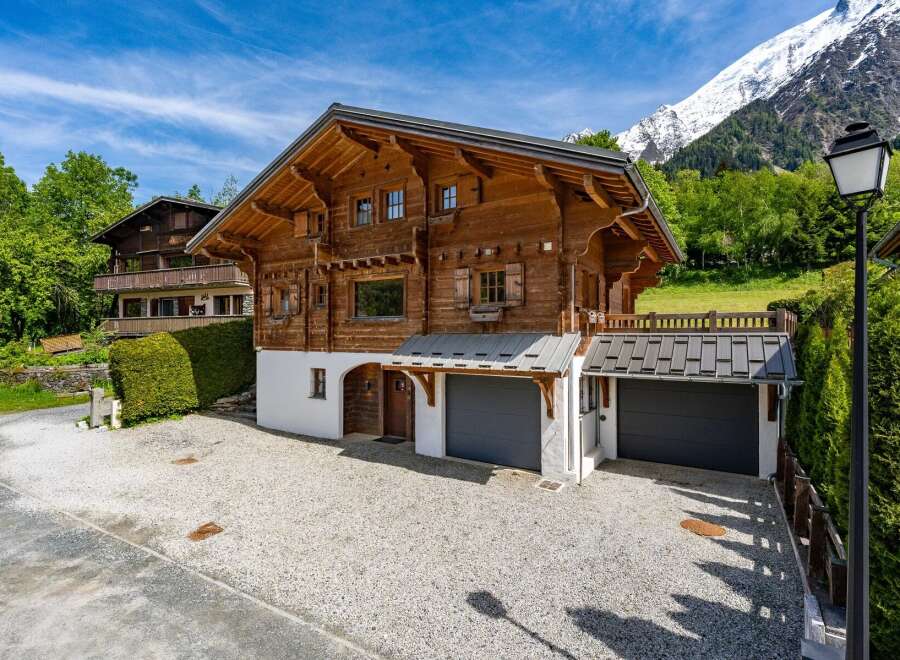 Experience alpine living in this stunning wooden chalet, nestled against a backdrop of majestic snow-capped mountains.