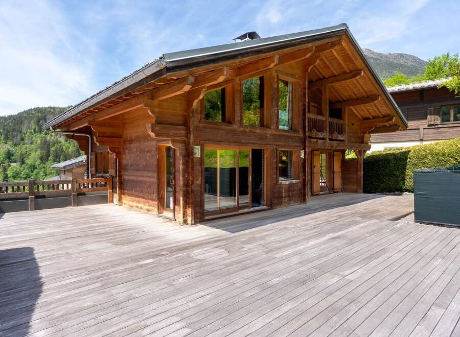 Experience luxury mountain living in this stunning wooden chalet, featuring expansive decks perfect for enjoying breathtaking alpine views.