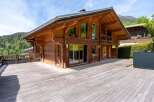 Experience luxury mountain living in this stunning wooden chalet, featuring expansive decks perfect for enjoying breathtaking alpine views.