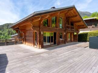 Experience luxury mountain living in this stunning wooden chalet, featuring expansive decks perfect for enjoying breathtaking alpine views.