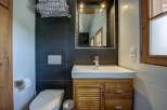 This modern bathroom features a sleek vanity with ample storage, a pristine white sink, and a chrome faucet.