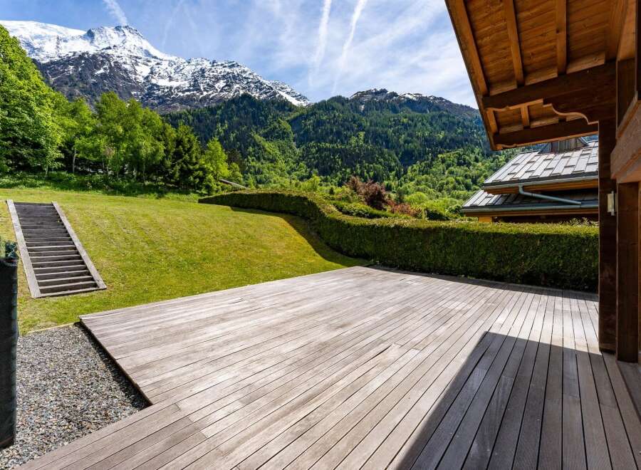 Experience breathtaking mountain views from this stunning property, featuring a spacious wooden deck perfect for outdoor entertaining.