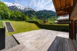 Experience breathtaking mountain views from this stunning property, featuring a spacious wooden deck perfect for outdoor entertaining.