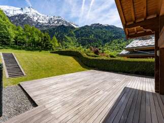 Experience breathtaking mountain views from this stunning property, featuring a spacious wooden deck perfect for outdoor entertaining.