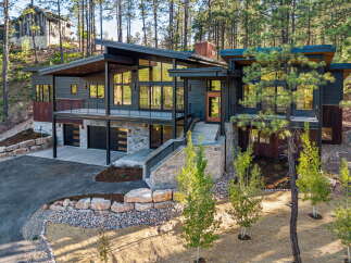 Experience modern mountain living in this stunning architectural home, nestled amidst a serene pine forest.