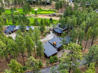 Nestled amidst a lush pine forest, this stunning property offers a luxurious retreat with direct access to a pristine golf course.