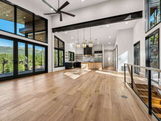 Experience luxury living in this stunning modern home featuring expansive floor-to-ceiling windows that showcase breathtaking mountain views.