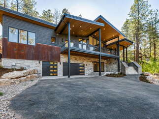 Experience modern mountain living in this stunning architectural home, nestled amongst towering pine trees.