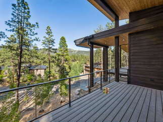 Experience luxury mountain living on this expansive deck, perfect for enjoying breathtaking forest views and crisp, clean air.