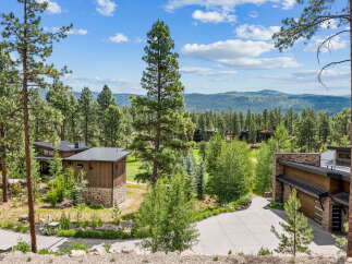 Nestled amidst a serene pine forest, this modern architectural masterpiece offers breathtaking mountain views.