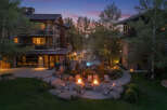Experience luxury mountain living with this stunning property featuring multiple buildings, a serene outdoor pool, and inviting fire pits perfect for evening relaxation.