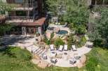 Experience outdoor living at its finest with this property's inviting patio area, featuring comfortable seating, fire pits, and two relaxing hot tubs surrounded by natural rock formations.