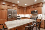 Experience culinary excellence in this beautifully appointed kitchen, featuring rich oak cabinetry and a stunning granite-topped island perfect for casual dining or entertaining.