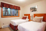 This charming bedroom features two comfortable twin beds, perfect for accommodating guests or family.
