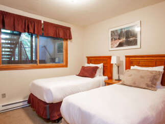 This charming bedroom features two comfortable twin beds, perfect for accommodating guests or family.