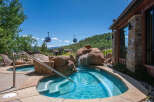 Experience ultimate relaxation in this stunning outdoor spa area, complete with a cascading waterfall feature and crystal-clear turquoise water.