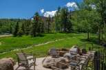 Enjoy the stunning mountain views from this outdoor living space, complete with a fire pit and comfortable seating.