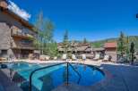 Enjoy a refreshing dip in the sparkling blue pool, surrounded by comfortable lounge chairs perfect for soaking up the sun.