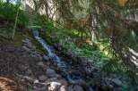 Experience serene living with this charming property featuring a beautiful natural rock waterfall cascading down a lush hillside.