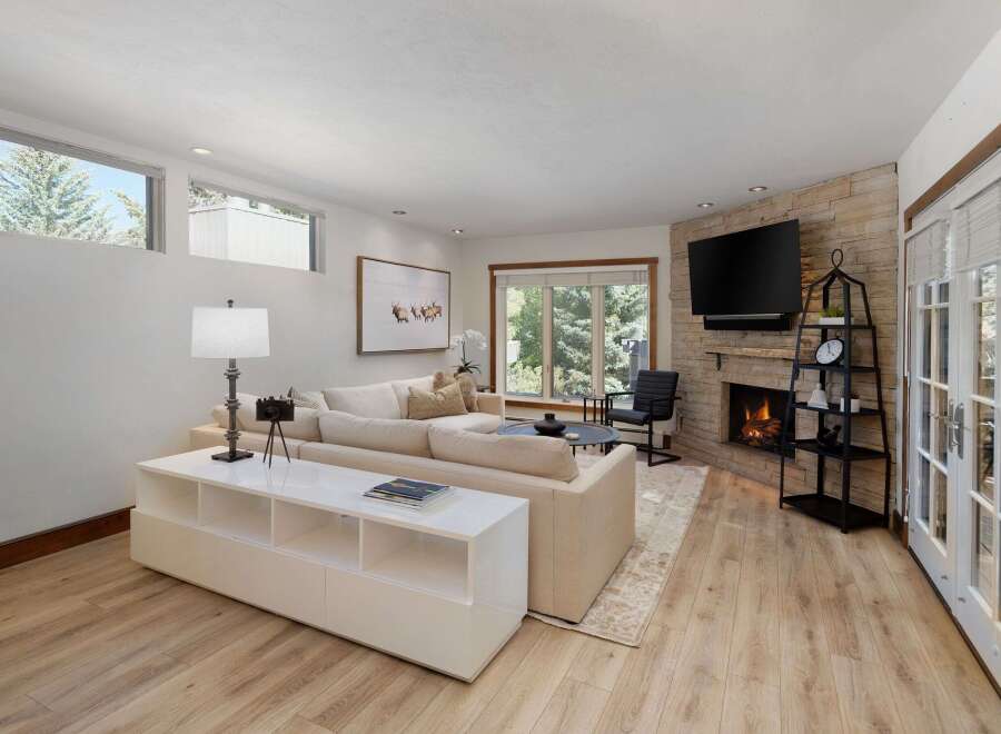 Experience modern living in this beautifully appointed living room, featuring a plush sectional sofa perfect for relaxation.