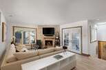 Experience cozy living in this inviting living room, featuring a stunning stone fireplace as the focal point.