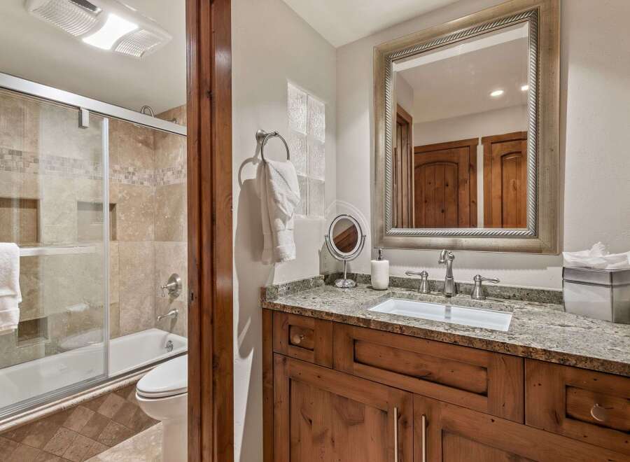 This bathroom features a luxurious bathtub and shower combination with elegant tile work.