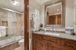 This bathroom features a luxurious bathtub and shower combination with elegant tile work.