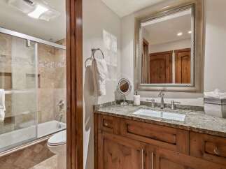 This bathroom features a luxurious bathtub and shower combination with elegant tile work.