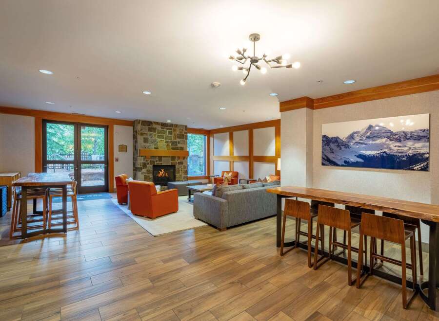 Experience ultimate comfort and style in this inviting living space, featuring a cozy stone fireplace and plush seating arrangements perfect for relaxation.
