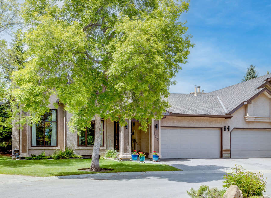 This stunning home features a beautiful stucco exterior and a spacious three-car garage, perfect for any car enthusiast.