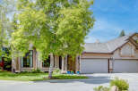 This stunning home features a beautiful stucco exterior and a spacious three-car garage, perfect for any car enthusiast.