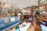 Step into this opulent living room, adorned with a stunning collection of framed art and elegant furnishings.