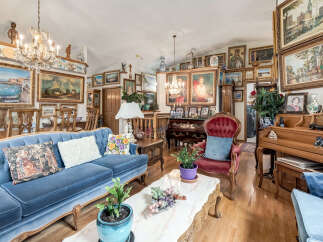 Step into this opulent living room, adorned with a stunning collection of framed art and elegant furnishings.