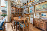 Experience elegant dining in this beautifully appointed room, featuring a large wooden dining table with upholstered chairs, perfect for hosting gatherings.