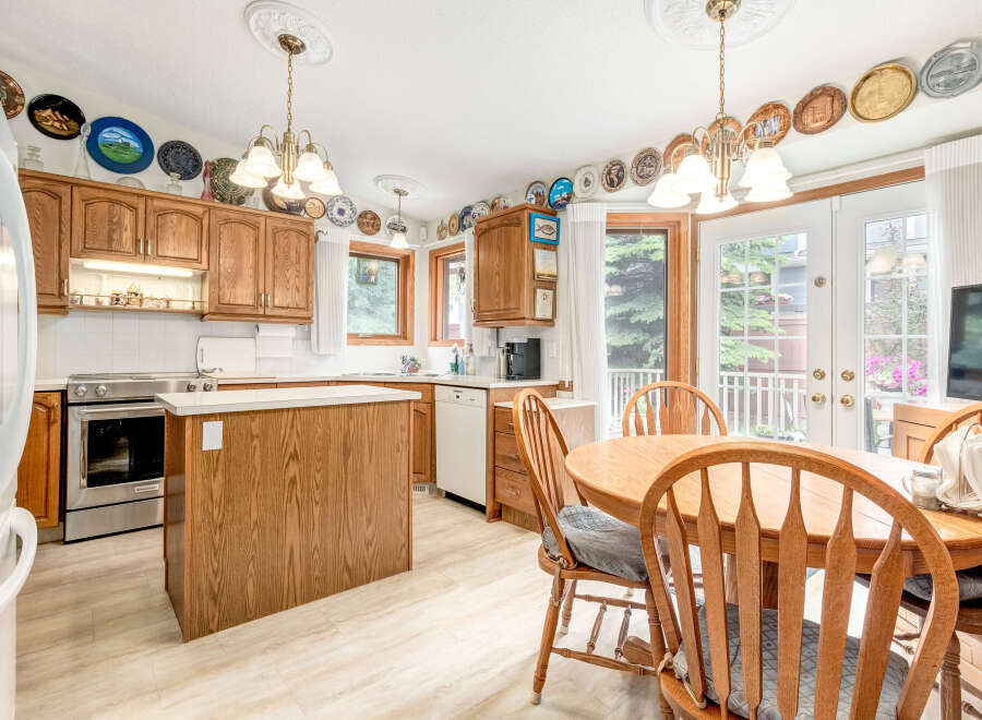 This charming kitchen boasts beautiful oak cabinetry and a spacious island, perfect for meal preparation and casual dining.